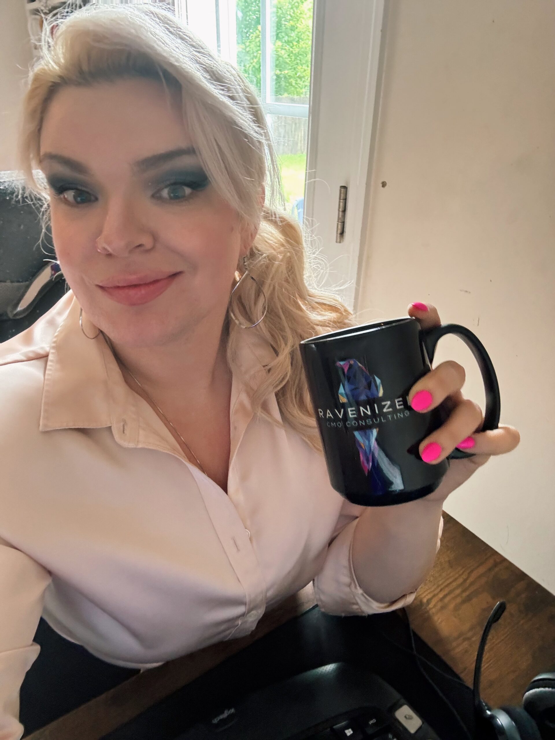 Raven youngblood working on website design holding a ravenized mug